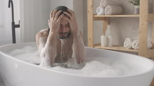 Man Washing in a White Bubble Bath