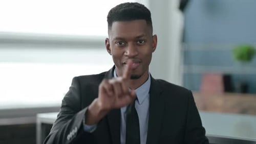 Man Smiling and Beckoning Closer in Business Attire