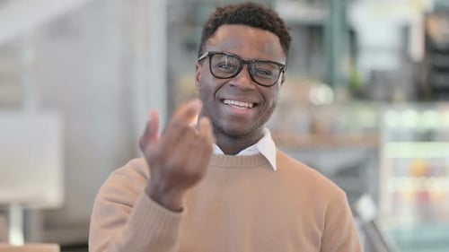 Young Adult Beckons Viewer with Friendly Invitation