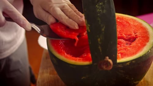 Bright Red Watermelon Scooped with Spoon in Kitchen