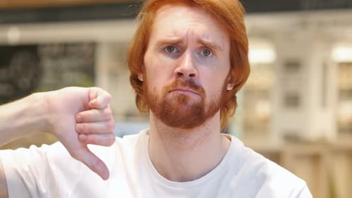 Thumbs Down By Redhead Beard Man in Cafe