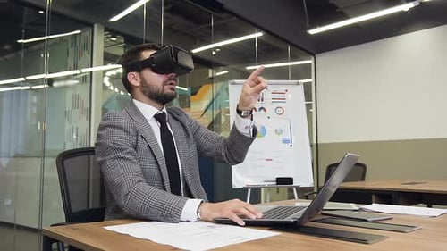 Man Using VR Headset at Desk in Office