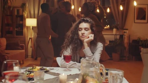 Bored Woman at Party While Friends Dance