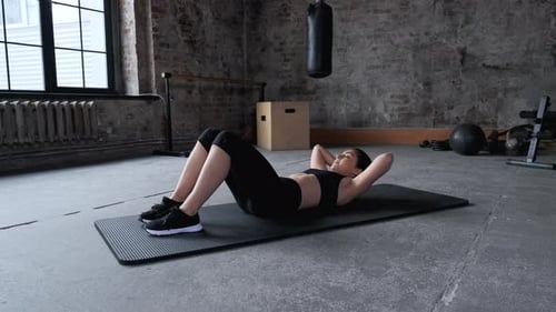 Woman Doing Crunches at Gym