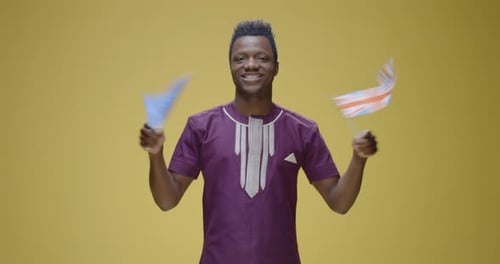 Smiling Young Adult Waving Two Flags