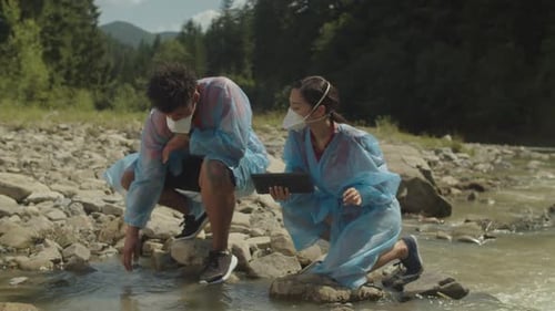 Scientists Testing Stream Water Quality by River