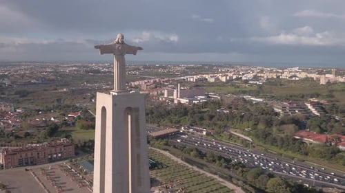 Monumental Statue Overlooks Bustling Cityscape from Above