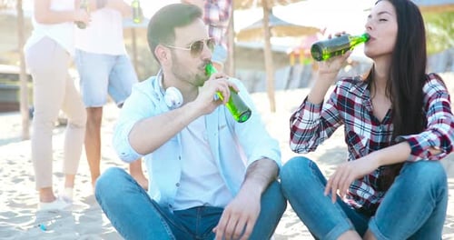 Happy People Drinking and Having Fun at Beach in Summer