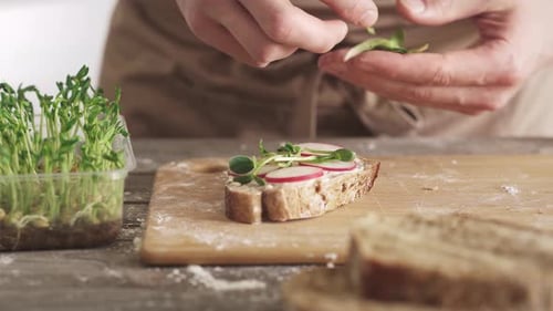 Man Preparing Healthy Radish and Sprout Sandwich