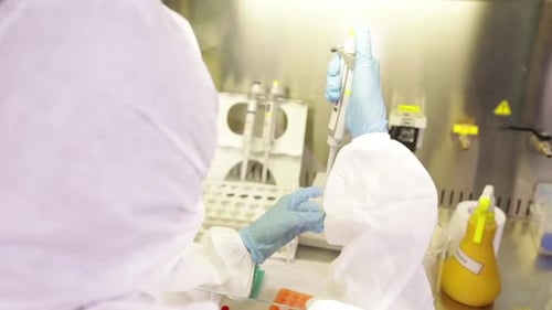 Scientist Pipetting Samples in a Bright Laboratory