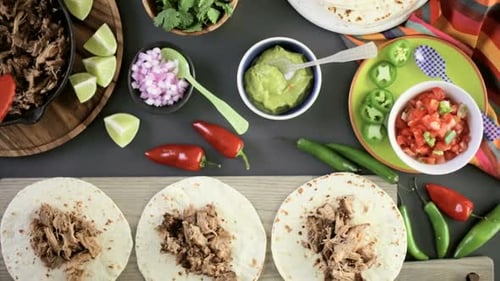 Preparing Flavorful Tacos with Toppings and Fresh Ingredients