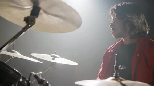 Young Male Drummer Playing Drums at Music Studio
