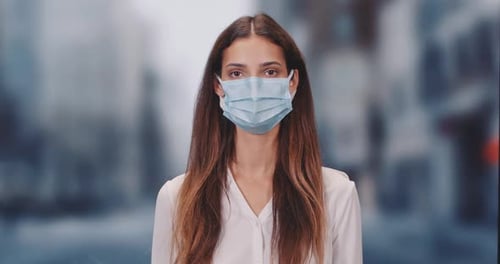 Woman Wearing a Face Mask in an Urban Setting