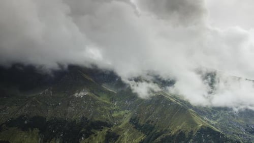 Aerial View of Mountain Peaks Covered in Clouds