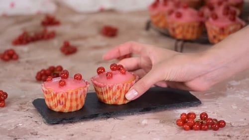 Cupcakes with Frosting Being Placed On Display
