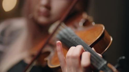 Young Woman Plays Violin Close Up
