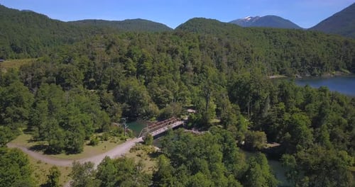 Perfect drone flight of a field that reaches the river and you can see the old mental bridge that cr