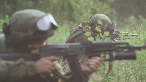 Soldiers in Camouflage with Assault Rifles Out of the Ambush in the Field Military Action