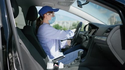 Health Care, Young Girl Driver in Goggles, Medical Mask and Gloves Works As Courier and Wipes