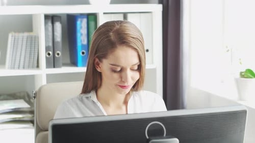 Young Woman Works at Home Office Using Computer.