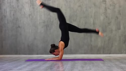 Young Woman Performs Yoga Routine in Studio