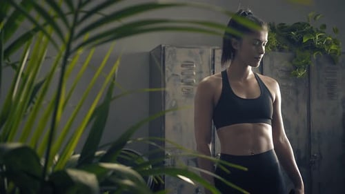 Woman in Workout Clothes Looking at Phone