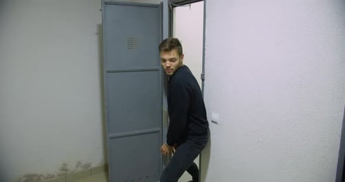 A Man In Handcuffs Escapes From A Prison Cell That Guards Forgot To Close