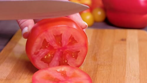 Close Up Women's Hands Cut Tomato