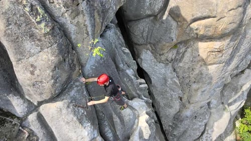 Strong Male Climber Climbing Steep Wall of Rocky Mountain