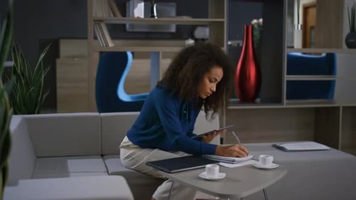 African American Businesswoman Work Tablet Write Notes on Video Call in Office