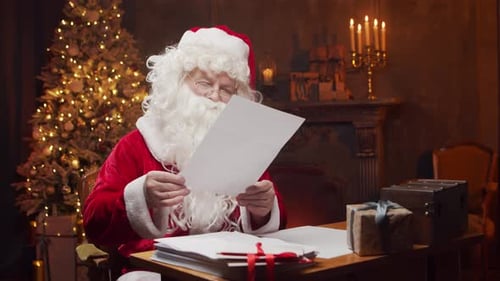 Santa Claus Reading Letter by Christmas Tree