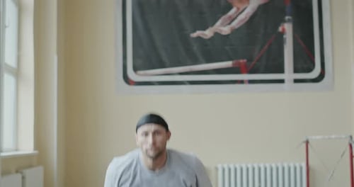 Male Athlete Acrobat in Gym Performing Somersault Jump Back in the Air - Slow Motion