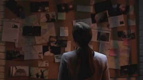 Female Detective Studying Crime Board at Night