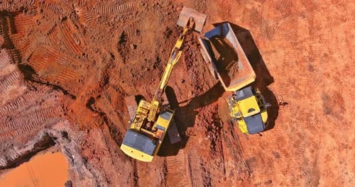 Preparing Place to Construction Residential House on Tractor Bucket is Filling a Soil in Truck