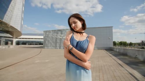 Stylish Woman Posing Outdoors in Blue Dress