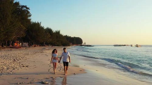 Teenage lovers posing on relaxing seashore beach lifestyle by transparent sea and white sand backgro