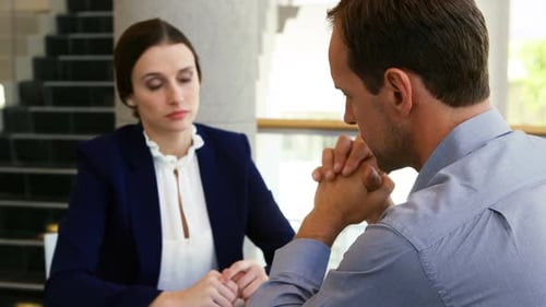 Executives discussing with each other in conference centre