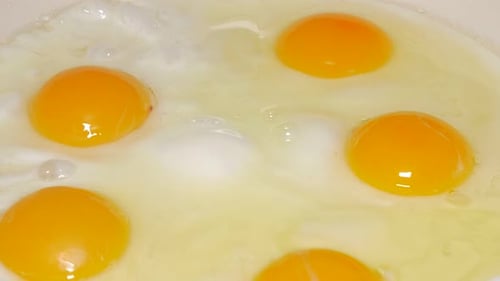 Bright Egg Yolks Fry in a Pan