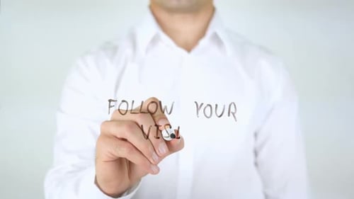Adult Writes "Follow Your Vision" Message on Screen