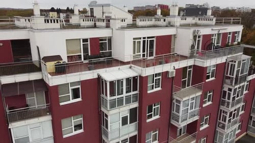 Aerial view of a drone flying over the residential buildings, roof shooting and architecture.