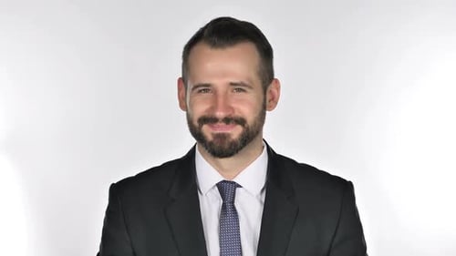 Man Smiling in Suit Against White Backdrop