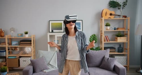 Woman Enjoys Virtual Reality Headset in her Home