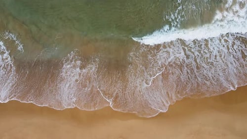 Aerial view of white sand beach and ocean wave