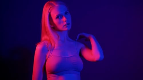 Glamorous Woman Posing in Red and Blue Lights