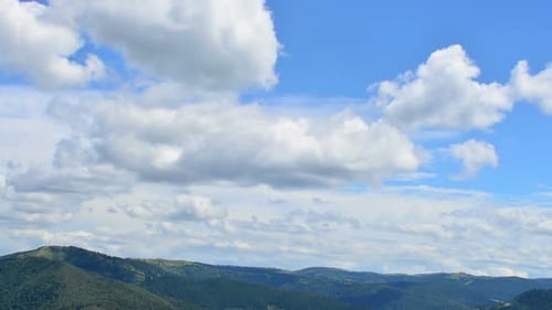 Rolling Green Mountains and Fluffy Clouds