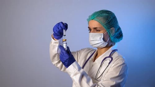 Medical Professional Draws Vaccine Into Syringe