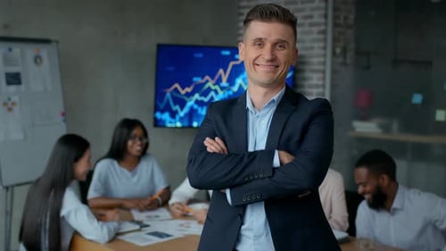 Confident Man Leads Tech Team Meeting