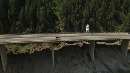 Scenic View of a Highway Beside a Mountain Range with a View of the Forest
