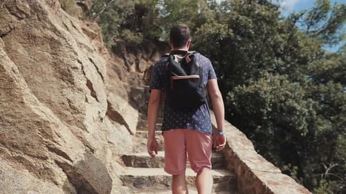 Man Hikes Up Stone Steps Through Nature