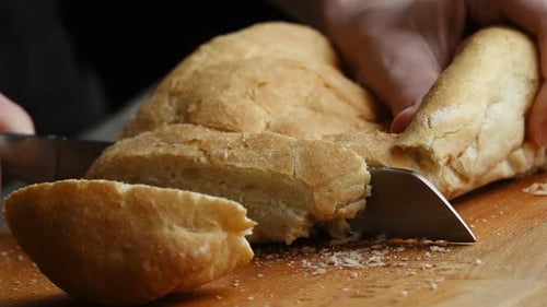 Cutting Fresh Bread Loaf with Serrated Knife